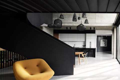 A Black Steel Stair Anchors the Addition of This Raw Concrete Home in Melbourne