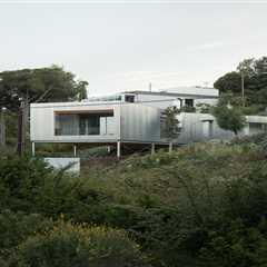 Wood Prefab Panels Cloaked in Galvanized Steel Form a Hillside Home in Barcelona
